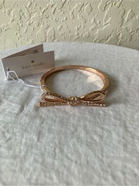 kate spade: Rose Gold Tone Skinny Mini Bow Bangle Clasp Bracelet